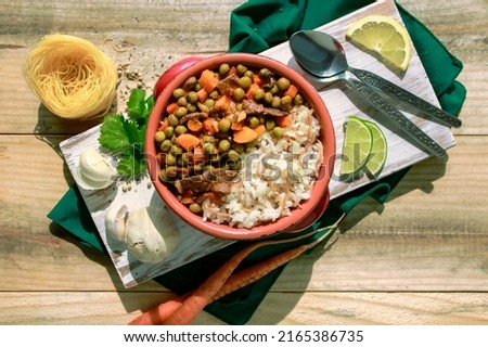 Bazella w Riz - Top view peas and rice stew with meat - Lebanese authentic dish - Middle Eastern healthy cuisine with red sauce Royalty-Free Stock Photo #2165386735