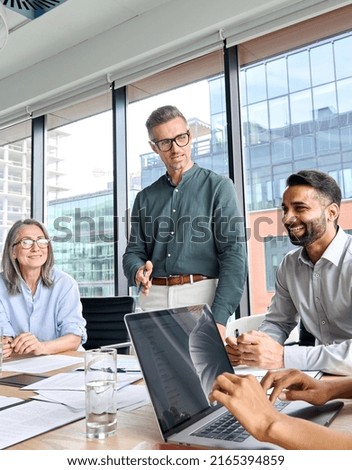 Male caucasian executive ceo businessman leader with diverse partners team, managers group at meeting. Multicultural professional businesspeople working together on business sales plan in boardroom. Royalty-Free Stock Photo #2165394859