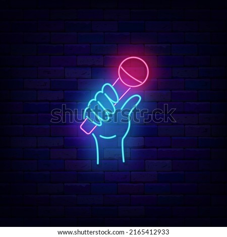 Hand with microphone neon sign. Stand up comedy logo. Karaoke singer item. Shiny glowing symbol. Editable stroke. Vector stock illustration