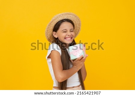 glad teen kid hold present box on yellow background