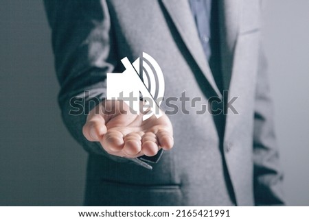 Mute icon. Man holding in his hand Royalty-Free Stock Photo #2165421991