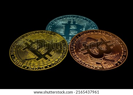 Gold,silver and bronze bitcoin isolated on black background. Bitcoin cryptocurrency.

