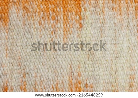 Surface of fabric texture in white and orange color. Colorful wool yarn cloth background. 