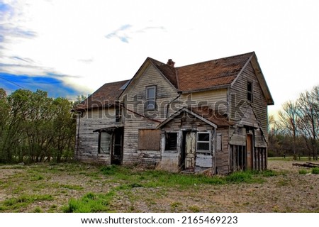 An old abandoned house stripped of external additions. Royalty-Free Stock Photo #2165469223