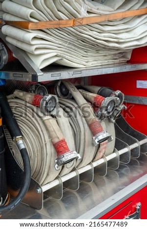 Fire truck with laying fire hose. The concept of fire-fighting equipment.