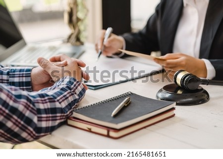 Justice lawyer meeting with contract papers and Judge gavel on tabel in courtroom. Attorney working in courtroom. Justice and law, attorney, court judge concept. Royalty-Free Stock Photo #2165481651