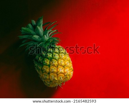Pineapple Tropical Fruit Yellow Minamal, Pineapple Vitamins, Vegetarian Diet,on red background.