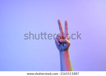 The Asian man s hands under the vivid color lighs.