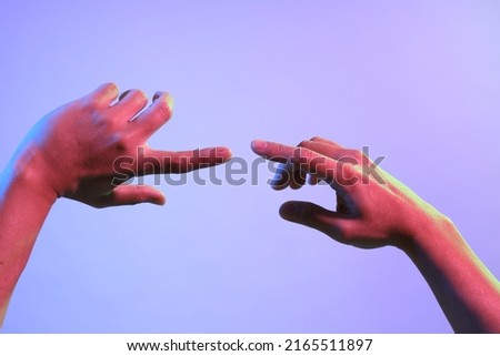 The Asian man s hands under the vivid color lighs.