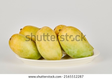 Plate of Kesar Mangoes on a white background Royalty-Free Stock Photo #2165512287