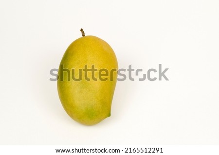 Closeup view of single Kesar Mango on a white background Royalty-Free Stock Photo #2165512291
