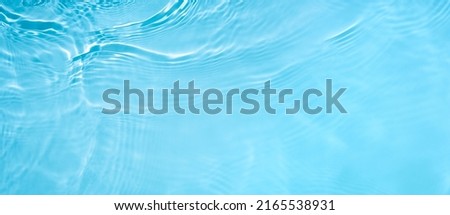 Transparent blue clear water wave surface texture with splashes and bubbles. Abstract summer banner background Water waves in sunlight with copy space Cosmetic moisturizer micellar toner emulsion Royalty-Free Stock Photo #2165538931