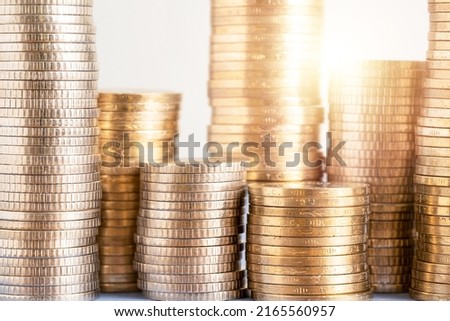 Close up photo of stacked coins on isolated background. Concept of investing money and making profits on new startup.