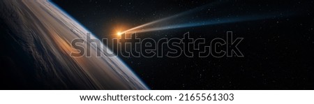 Comet, asteroid, meteorite flying to the planet Earth. Glowing asteroid and tail of a falling comet threatening the safety of the Earth. Elements of this image furnished by NASA.  Royalty-Free Stock Photo #2165561303