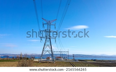 High voltage towers with hanging power lines and power station