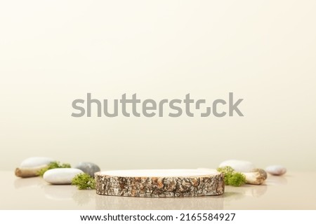 Wood podium with green leaves and natural stones. Abstract podium for organic cosmetic products. Natural stand for presentation and exhibitions. Front view Royalty-Free Stock Photo #2165584927