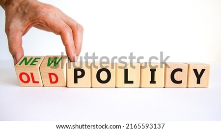 New or old policy symbol. Businessman turns wooden cubes and changes words 'old policy' to 'new policy'. Beautiful white table, white background. Business, old or new policy concept. Copy space. Royalty-Free Stock Photo #2165593137