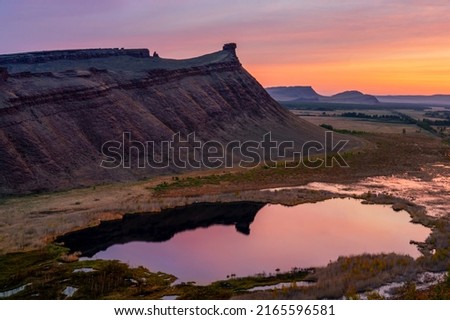 Chest butte or First Sunduk against blue sky. Sunduki mountain range from Devonian sandstone stone in the valley of the Bely Iyus River in Khakassia, Russia. Royalty-Free Stock Photo #2165596581