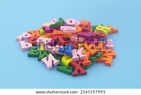 Many colorful English letters on blue background.