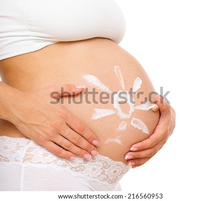 Image of pregnant woman touching her belly with hands, isolated over white