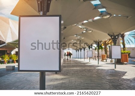 Empty lightbox on the street of a city. Billboard placeholder mock-up on a city boulevard in an alleyway outdoors, selective focus