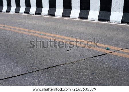 Concrete Road with Black and White Barrier.