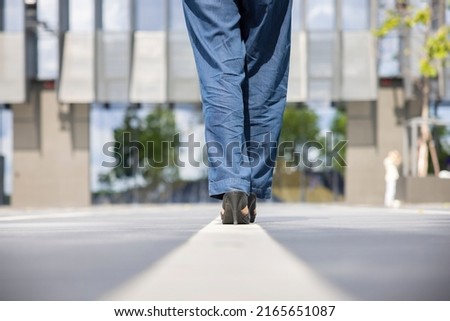 Woman feet walking stepped on a white line moving forward for success. 