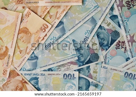 turkish money, top view fifty and hundred turkish lira banknotes as a background. money background or surface concept photo with heap of lira that is currency of Turkey or Turkiye. finance concept