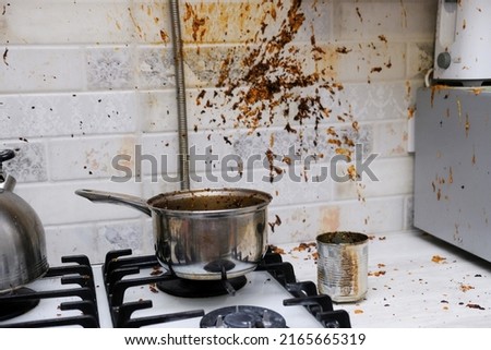 Oil stains on the walls, dirty stains on kitchen wall, Dirty Cooking. forgot to turn off the gas stove, condensed milk explosion Royalty-Free Stock Photo #2165665319