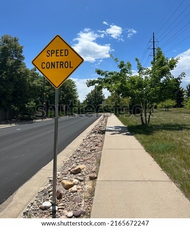 Speed control sign in suburban neighborhood