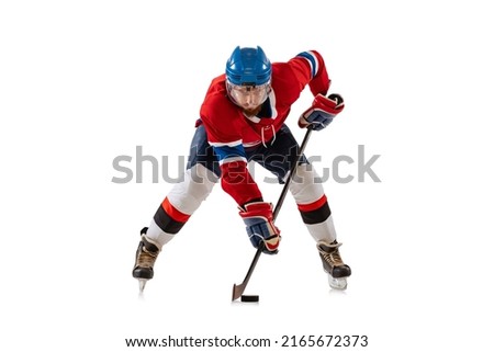 Defence. Young male hockey player in sports uniform training isolated on white background. Sportsman wearing equipment and helmet skating. Concept of sport, motion, movement, action, ad