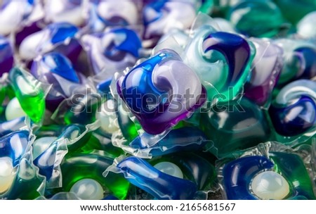 Washing capsules. Capsules with liquid powder for washing things in the washing machine. Capsules background. Royalty-Free Stock Photo #2165681567
