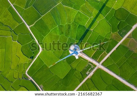 Landscape with Turbine Green Energy Electricity, Windmill for electric power production, Wind turbines generating electricity on rice field at Phan Rang, Ninh Thuan, Vietnam. Clean energy concept. Royalty-Free Stock Photo #2165682367
