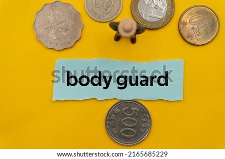 body guard.The word is written on a slip of paper,on colored background. professional terms of finance, business words, economic phrases. concept of economy.