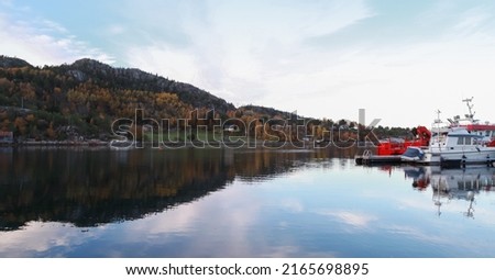 Panoramic Norwegian landscape photo with small boats moored at floating pier. Snillfjord, Sor-Trondelag, Vingvagen fishing camp 