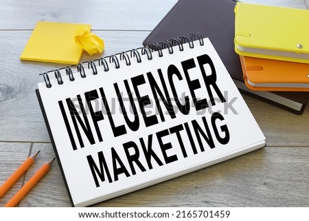 text on notepad paper INFLUENCER MARKETING in office, business concept