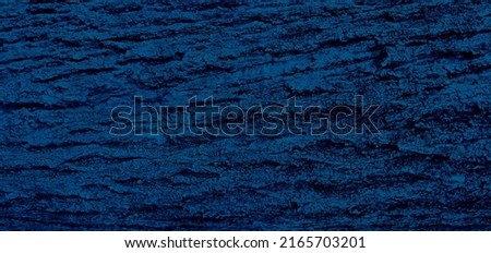 abstract blue bark background of a tree in the forest with relief. texture of tree bark horizontal image. wooden texture background. abstract dark blue background (focused at center of image).