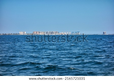 Tourist area of apartments in La Manga del Mar Menor seen from inside said sea on a clear blue sky day