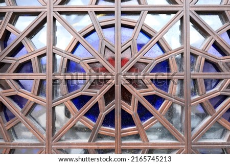 Wooden ornament with colorful glass as background