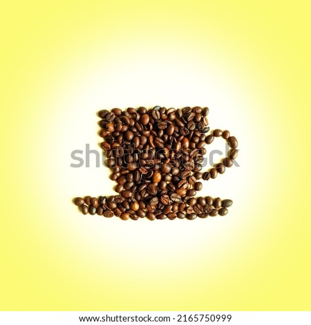Cup with saucer made of coffee beans against gradient yellow background. Flat lay, copy space. Coffee art. Creative layout. Morning coffee.