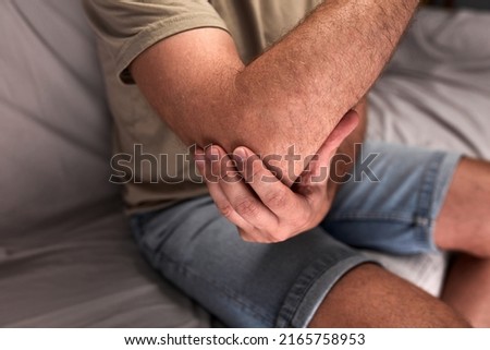 Adult man with elbow, arm and wrist pain.
