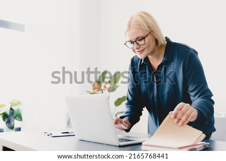 Smart caucasian young businesswoman ceo boss employee teacher freelancer working on laptop online, typing, e-learning, e-commerce, tutoring on distance remotely in office Royalty-Free Stock Photo #2165768441