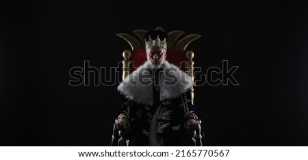 medieval king on the throne Royalty-Free Stock Photo #2165770567