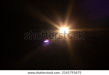 Real photographic Lens Flare light over black background easy to add overlay or screen filter over photos