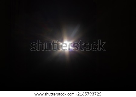 Real photographic Lens Flare light over black background easy to add overlay or screen filter over photos