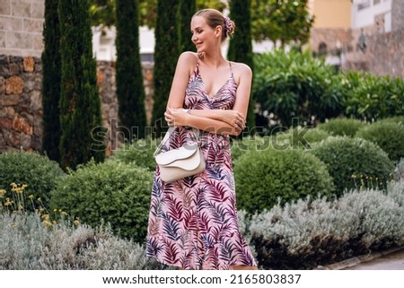 Elegant blonde woman enjoy her luxury vacation in Italy, stylish summer dress.