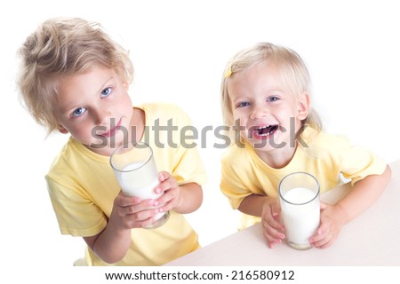 Two cute girls drinking milk isolated on white background
