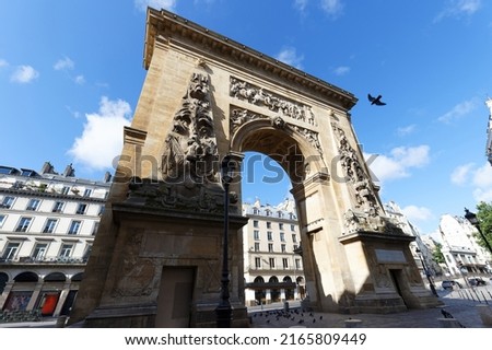 Porte Saint-Denis is a Parisian monument located in the 10th district , at the crossing of the Rue Saint-Denis continued by the Rue du Faubourg Saint-Denis. Paris. France. Royalty-Free Stock Photo #2165809449