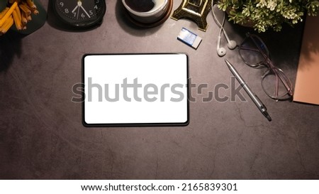 Female workspace with digital tablet, stylus pen, coffee cup earphone and notebook on office desk.	