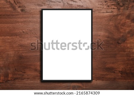 Picture frame on a white wooden wall white frame. Blank Mockup .